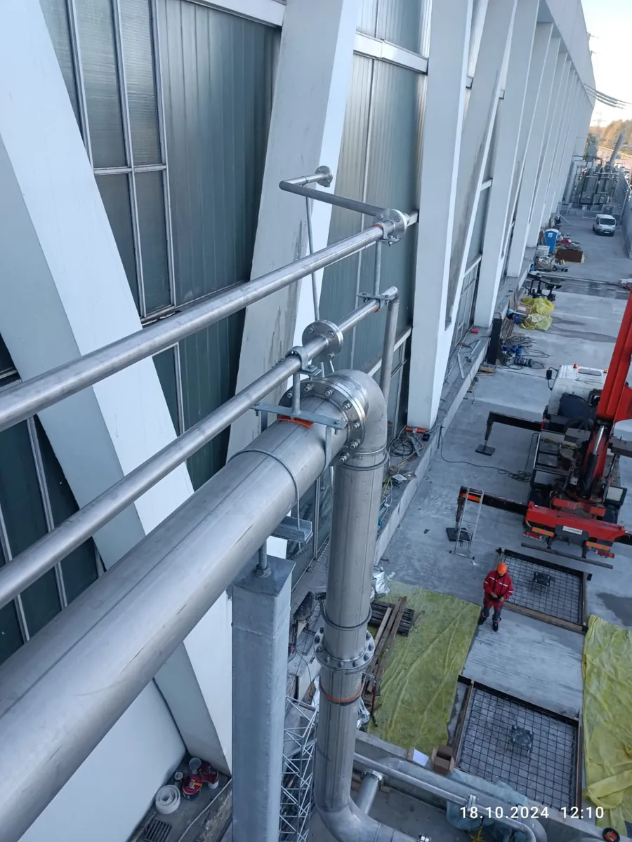 Réseaux de tuyauterie montés le long d’une façade d’usine